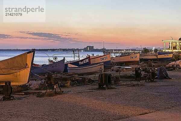 Pomorie  Bulgaria  September 15  2020: Beachfront sea panorama with fishing boats in the town and seaside resort on Black sea  sunset view  Europe