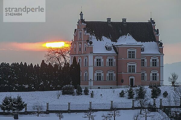 A pink castle in winter with a sunset in the background  Freudental Castle  Allensbach  Lake Constance  Baden-Württemberg  Germany  Europe