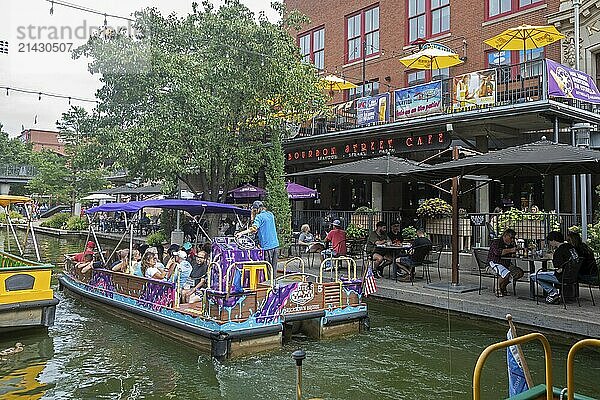 Oklahoma City  Oklahoma - Tourists ride a canal boat on the Bricktown Canal in Bricktown  a popular tourist neighborhood.