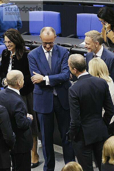 Olaf Scholz (SPD)  Federal Chancellor  greets Friedrich Merz  CDU  and Christian Lindner in plenary in front of the session in the German Bundestag  Berlin  13 November 2024