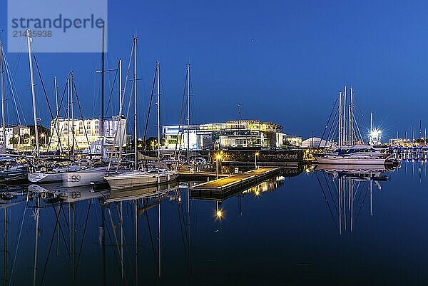 La Rochelle  France  August 6  2018: Sailing ships at the Marina at night. Enclosed by its medieval towers  the picturesque harbour is now lined with seafood restaurants and bars  Europe