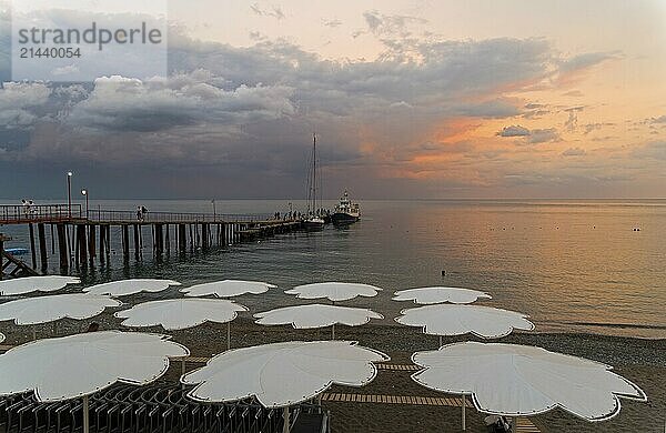 View of evening sunset sky from the empty beach of the resort town of Sudak. Crimea