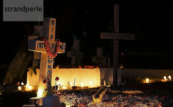 People from Christian community light candles and offer prayers on the grave of their relative during the All souls day observation  in Guwahati  India on 2 November 2024. All Souls' Day is a Christian holiday dedicated to honoring and praying for the souls of the departed