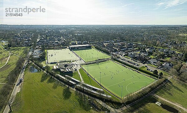 Aerial shot of a sports field with people playing on it