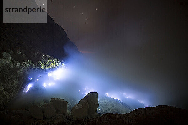 Blue flames of molten sulfur burning at the mine inside the crater of Kawah Ijen volcano  Banyuwangi  Java  Indonesia