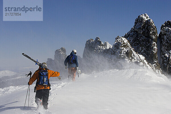 Skiers and a snowboarder hiking in the Kirkwood Backcountry. Kirkwood Ski Resort  Kirkwood California.