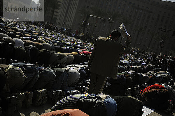 Thousands of protesters break for Friday prayers in Tahrir Square in Cairo  Egypt on February 4  2011. Over 200 000 protesters congregated in the square on Friday to demand that President Hosni Mubarak step down from his 30-year reign of power. Egypt erupted in mass protests on Jan. 25  2011 with protesters chanting that they will not leave Tahrir Square until Mubarak leaves office. Mr. Mubarak has said he will not run for reelection but has refused to step down from power  and has sent his armed supporters to violently attack the crowds of protesters. Human rights organizations report that at least 150 people have been killed since the protests began.