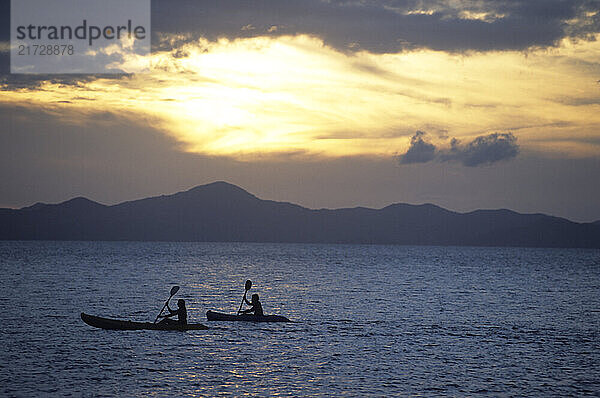 Sea Kayakers explore the Coron Islands at sunset  Palawan Islands  Phillippines. (Photo by Greg Von Doersten/Aurora)