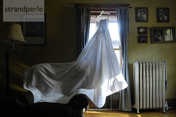 A wedding dress hangs in a spare bedroom  ready for the big day in Chicago  Ill.  on Sept. 1  2007.