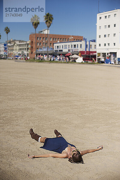 Erinn Deshinsky lies in the sand on Venice Beach in Los Angeles  Calif.  on Tuesday  Nov. 2  2010. Behind her is the famed Venice Boardwalk.