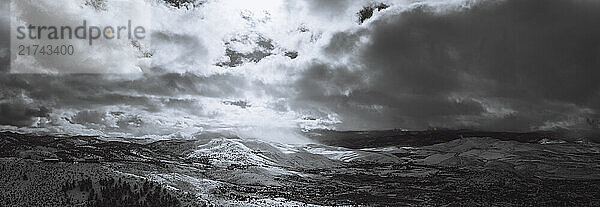 Dramatic light illuminates a mountain range in the background on a cloudy afternoon overlooking Reno  Nevada.