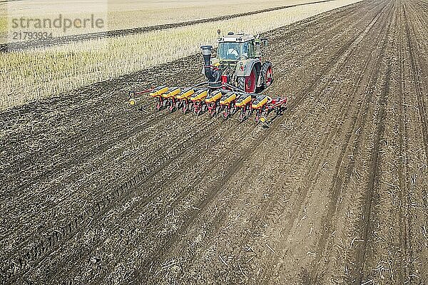 Farmer seeding crops at field. Seeding Aerial View