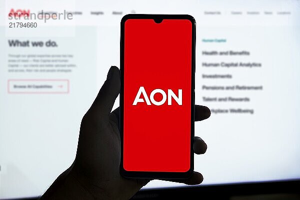 Smartphone displaying logo of Aon PLC  a British multinational professional services firm that sells a range of financial products.