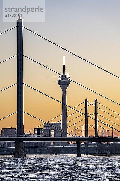 Sunset on the Rhine near Düsseldorf  skyline of the city centre with Rhine Tower  Rheinkniebrücke  behind  Oberkassler Brücke  North Rhine-Westphalia  Germany  Europe