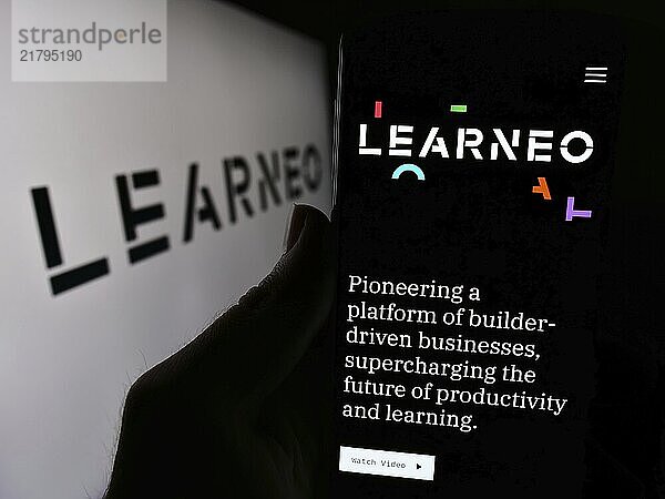 Stuttgart  Germany  04-02-2024: Person holding smartphone with webpage of US education platform company Learneo Inc. in front of logo. Focus on center of phone display  Europe