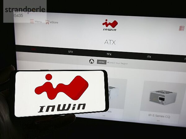 Stuttgart  Germany  02-24-2024: Person holding smartphone with logo of Taiwanese computer hardware company InWin Development Inc. in front of website. Focus on phone display  Europe