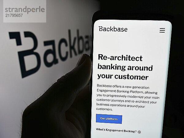 Stuttgart  Germany  07-11-2024: Person holding smartphone with webpage of Dutch fintech company Backbase B.V. in front of business logo. Focus on center of phone display  Europe