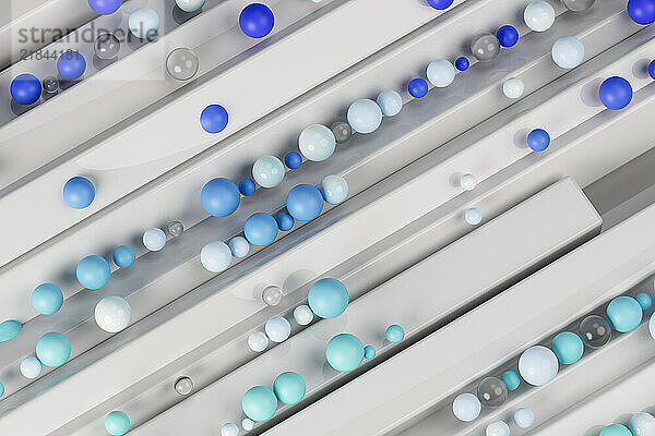 Different shades of blue colored marbles on metal structure