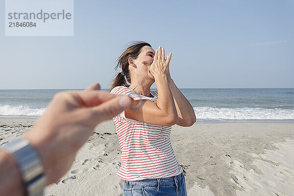 Happy woman enjoying with man at beach