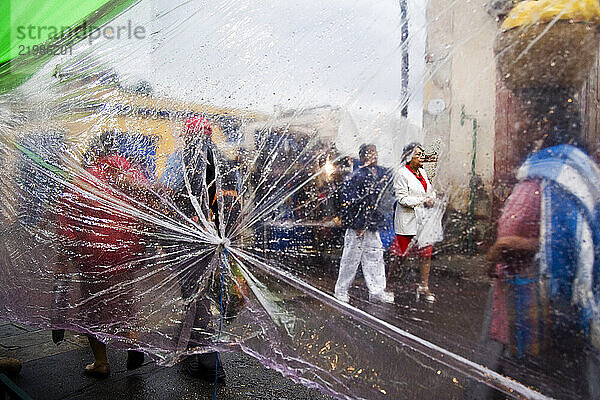 Pedestrians in the street on a rainy afternoon in Oaxaca City  Oaxaca  Mexico