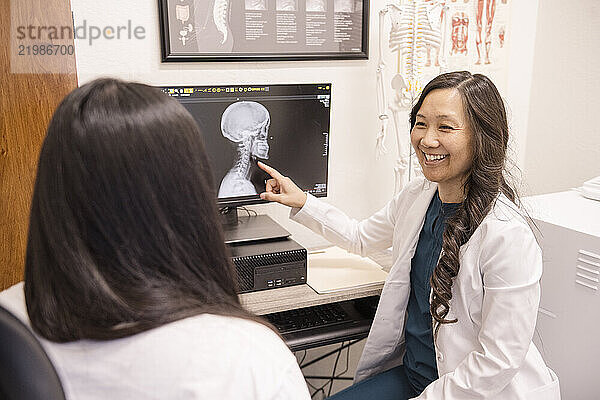 Doctor showing patient x-ray on computer