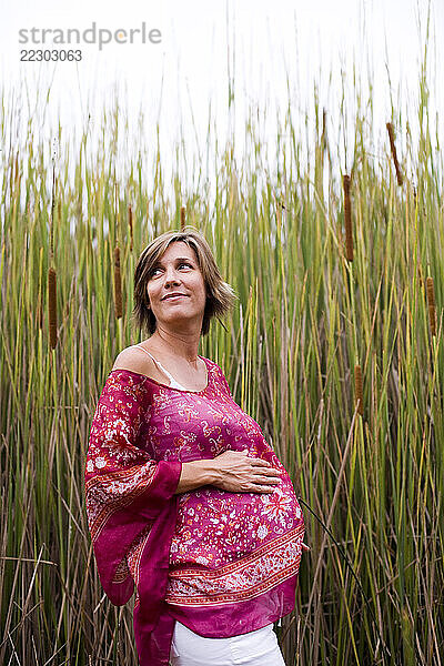 An expecting mother poses for the camera in Oceanside  CA.